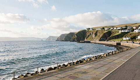 A wide view of Douglas bay with the promenade and the sweep of the bay under a bright sky.